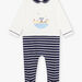 Baby boy's striped romper with koala motif at the beach