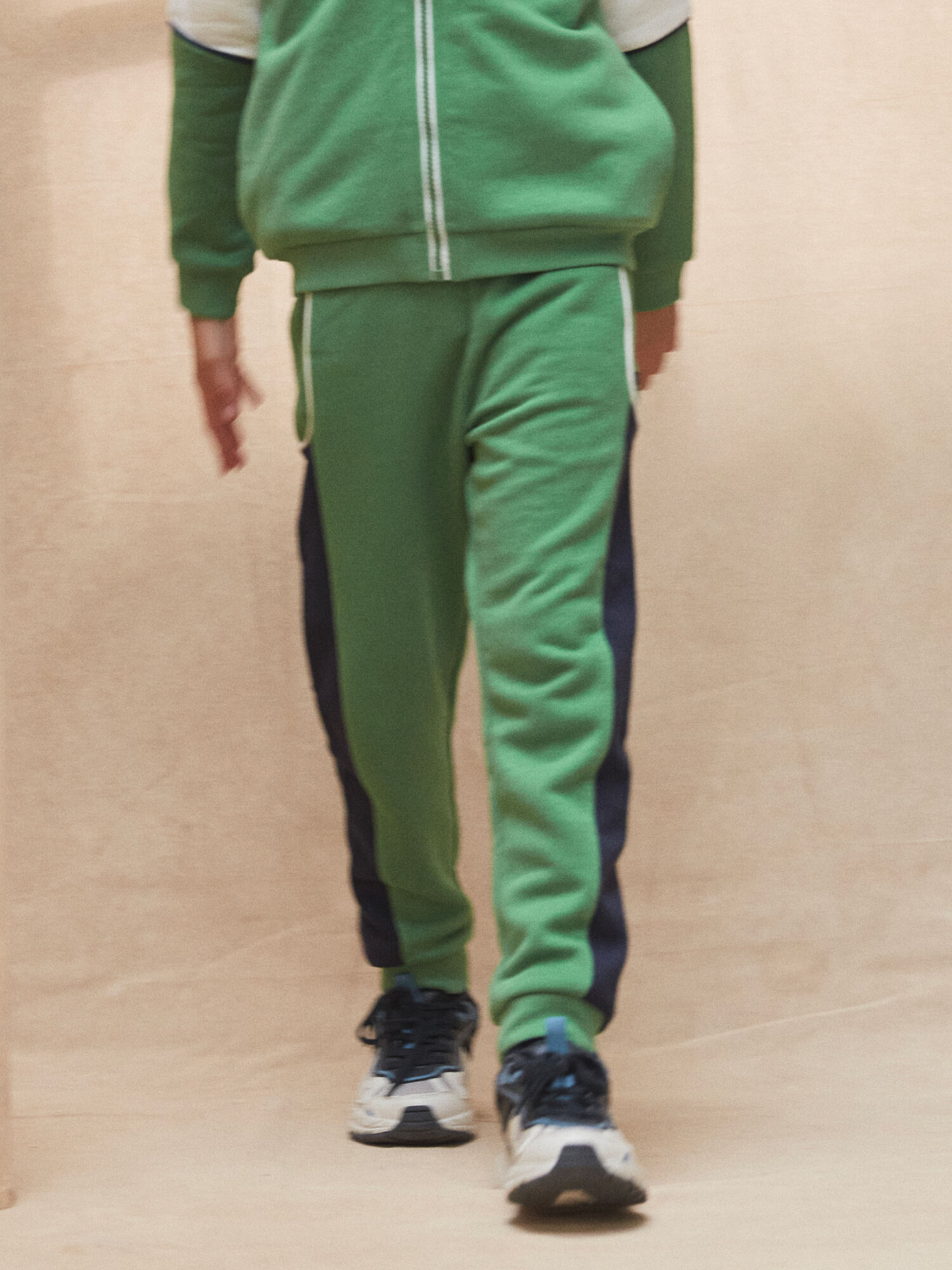 Green jogging pants with contrasting stripes