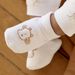 Off white birth slippers with giraffe print