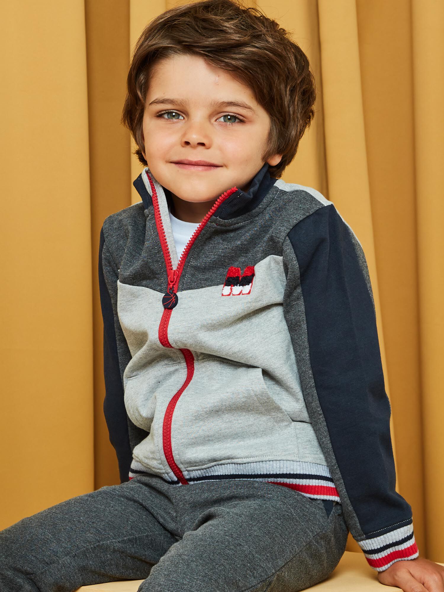 Grey and red basketball jogging top